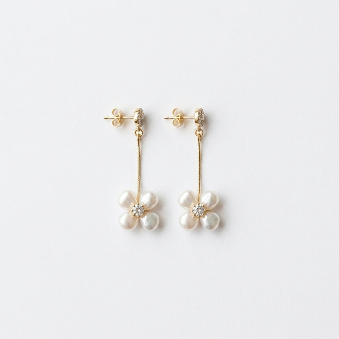 Flat lay of Dallas earrings with Austrian crystals and freshwater pearls, sterling silver post, gold plating, on white background