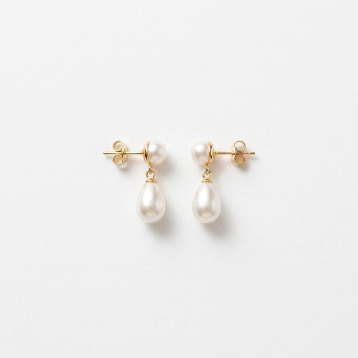 Delicate Ethan earrings with faux pearls, sterling silver, and gold plating displayed on a white background with subtle shadow, highlighting craftsmanship and fine details.