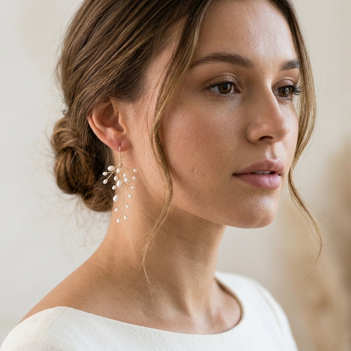 Delicate kehlani earrings with freshwater pearls in sterling silver or gold-plated sterling, shown on a model with natural lighting and clean ivory background.