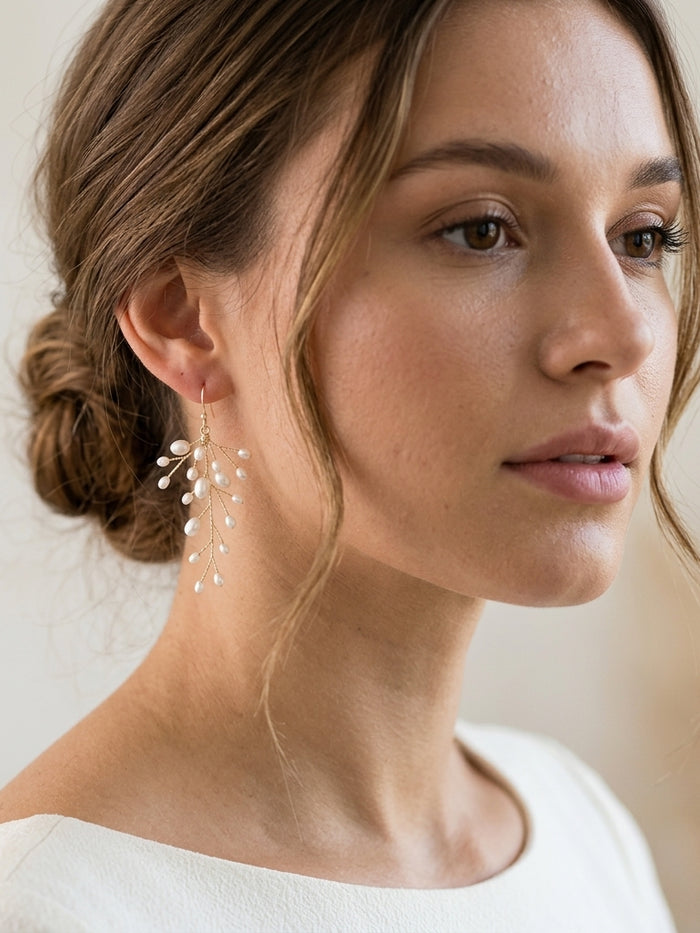 Delicate kehlani earrings with freshwater pearls in sterling silver or gold-plated sterling, shown on a model with natural lighting and clean ivory background.