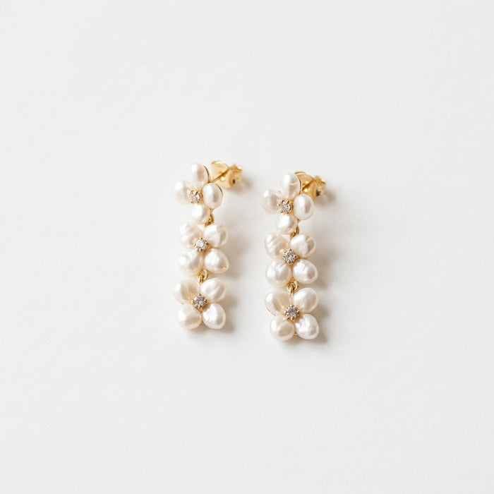 Delicate Luka earrings with Austrian crystals and freshwater pearls in sterling silver with gold plating, displayed on a white background.